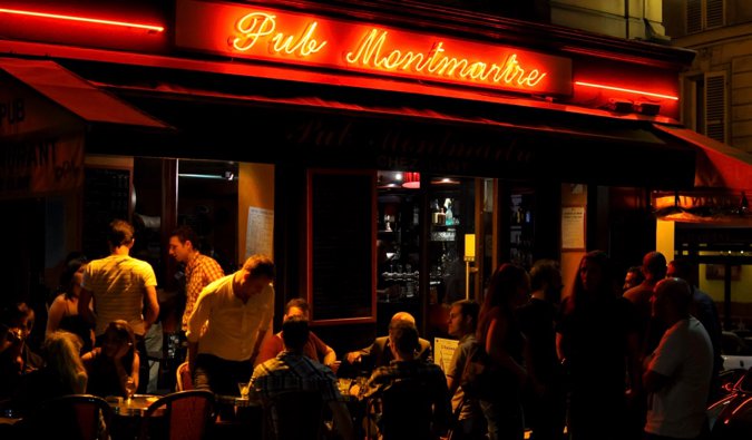 The patio of a busy bar a night in Paris, France