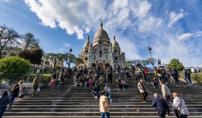 The crowded steps of Sacre Coeur atop Montmartre in Paris, France