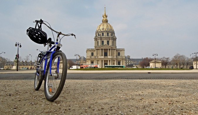 A single Fat Tire Tour bicycle parked on the sidewalk in Paris, France